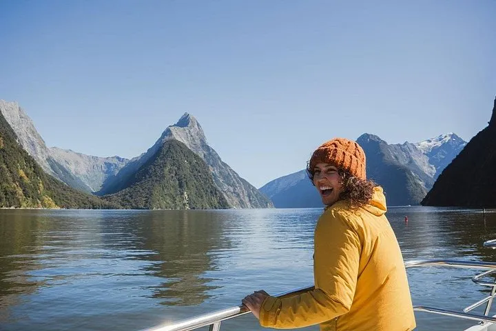 Small group at a scenic stop on the Milford Road before a Milford Sound boat tour from Te Anau in New Zealand