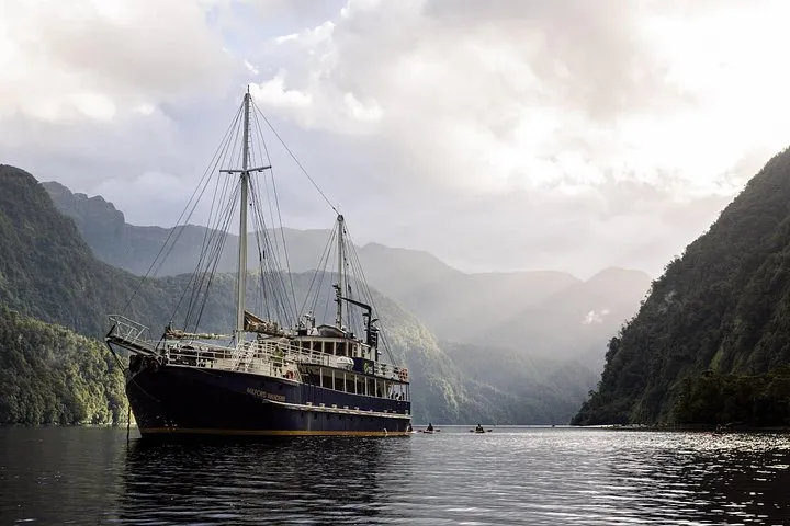 Sailing scow at anchor on a Doubtful Sound overnight cruise in Fiordland, New Zealand