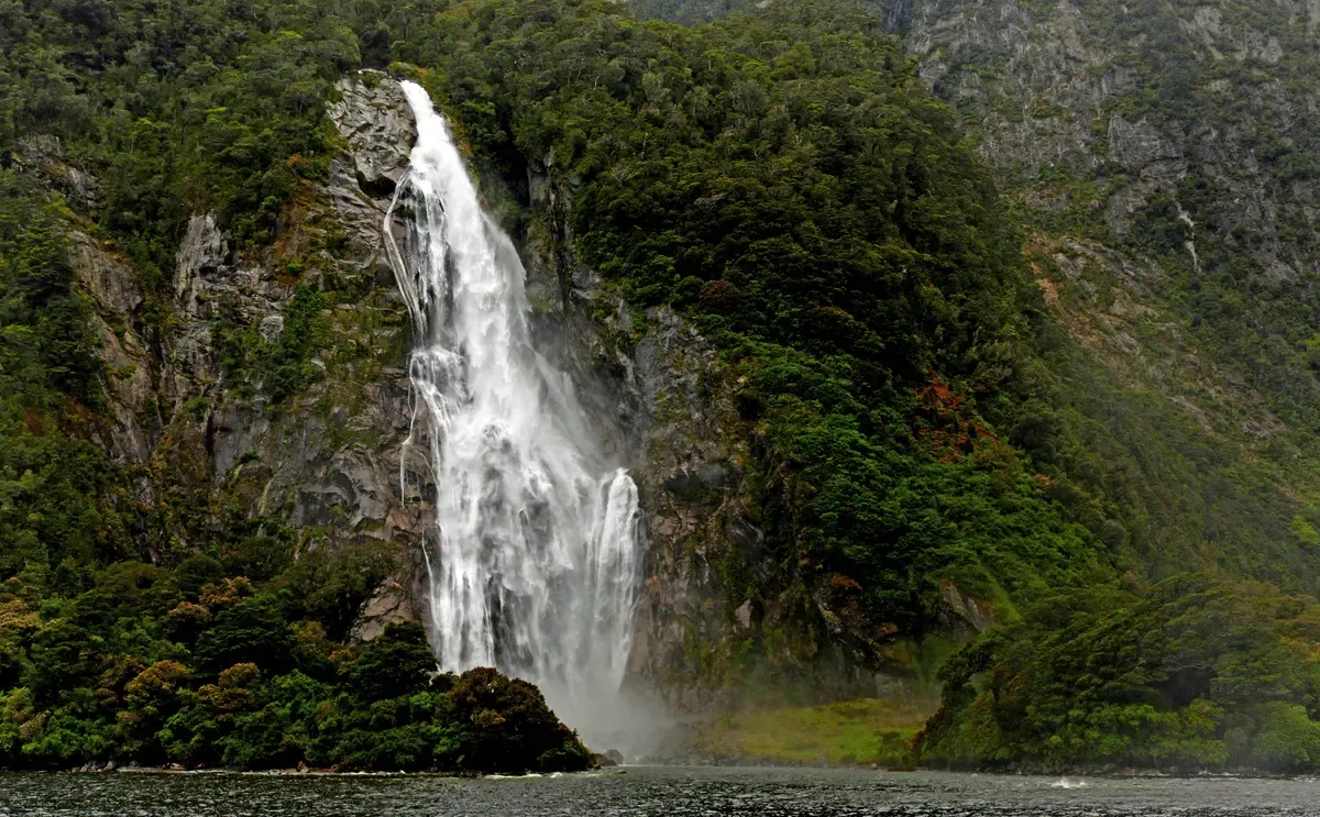 Lady Bowen Falls dropping into the fiord beside the terminal, passed by every Milford Sound boat tour