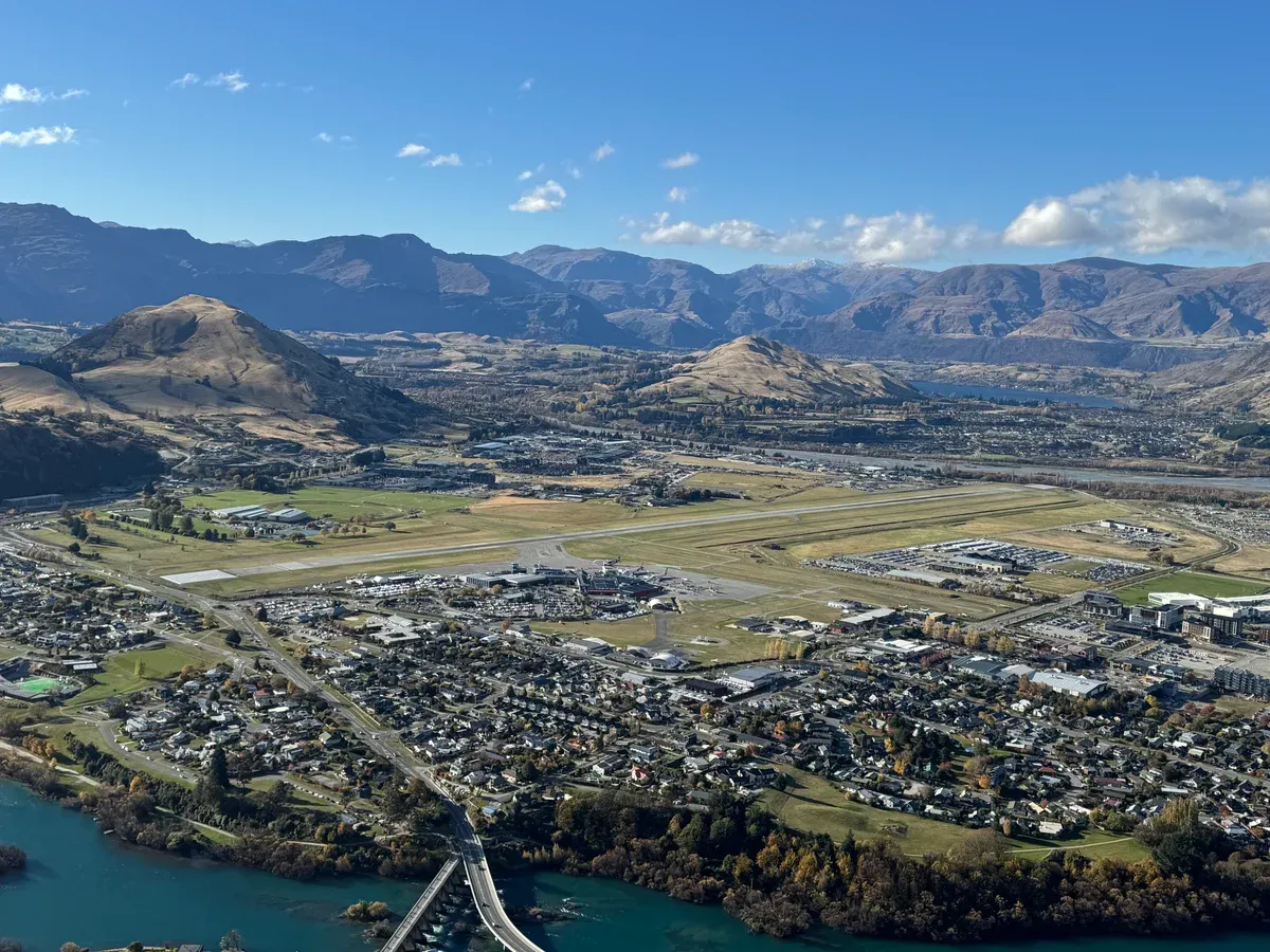 Queenstown Airport and the town with surrounding ranges, the departure point for a flight to a Milford Sound cruise